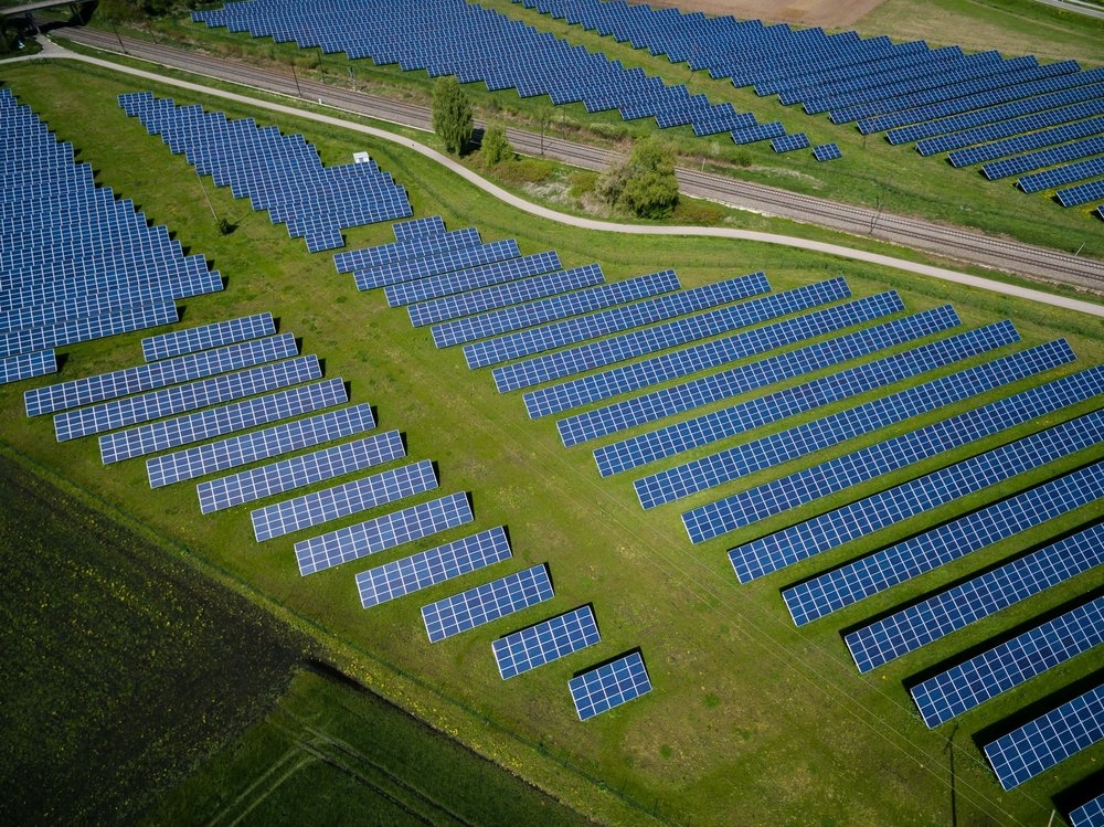 Aerial photography of grass field with blue solar panels